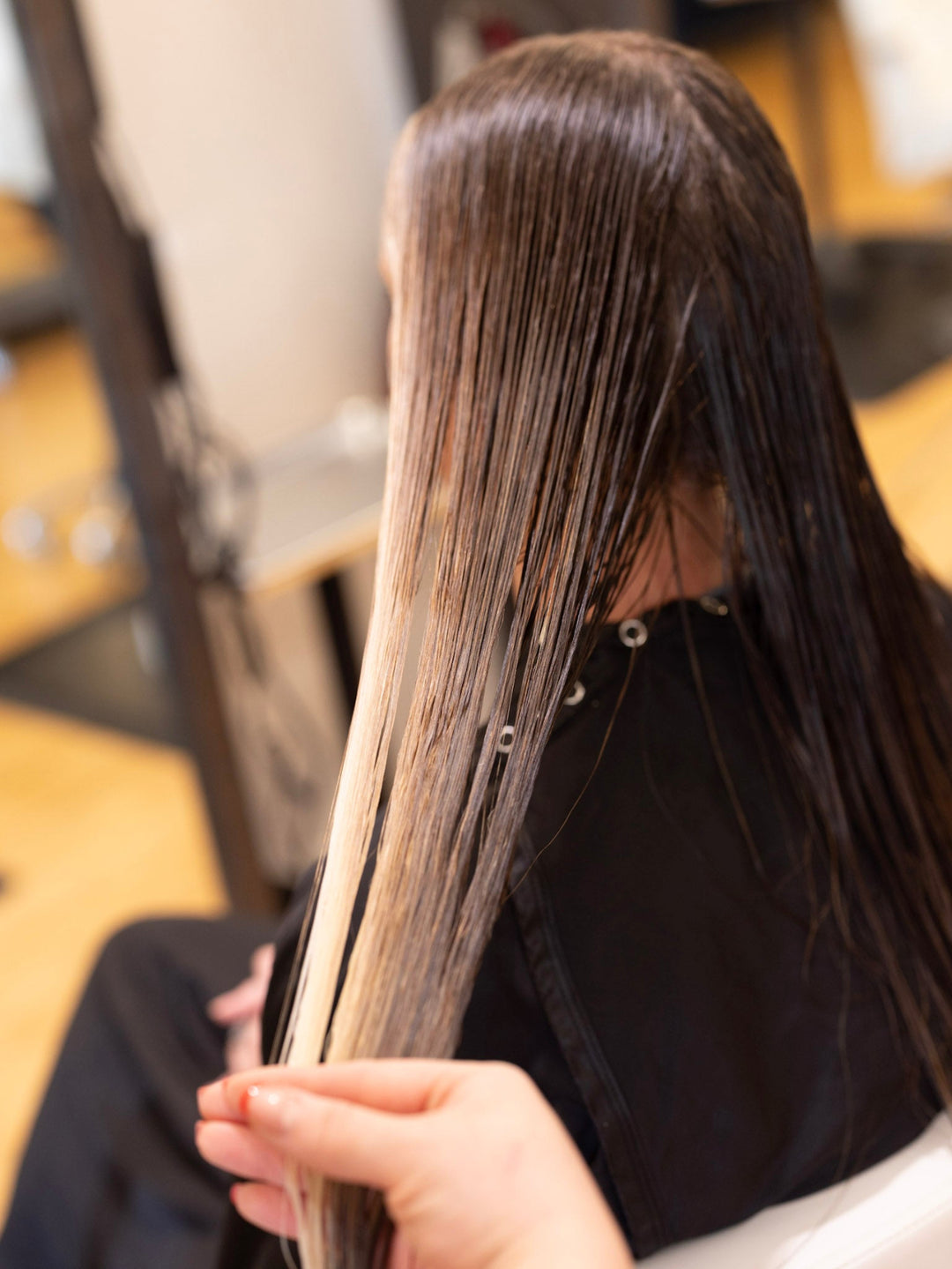 Hair stylist sectioning brunette hair at Jayden Presleigh The Salon in Carlsbad, CA