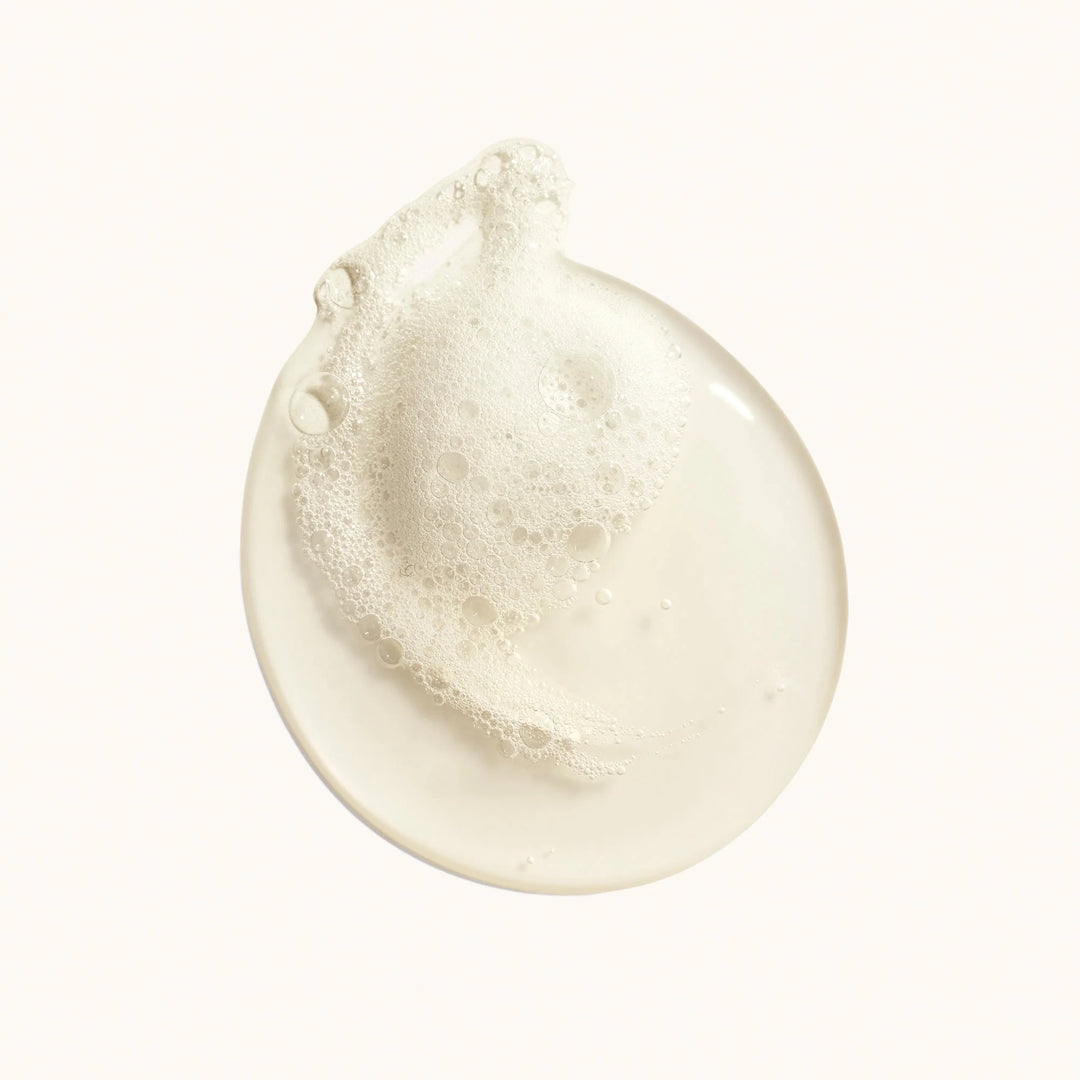 Close-up of a white cream or lotion droplet on a white background