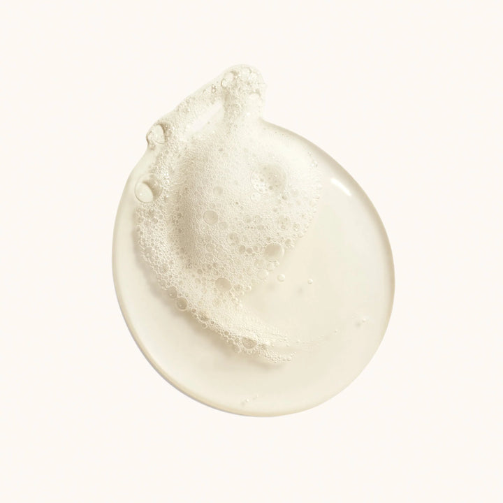 Close-up of a white cream or lotion droplet on a white background