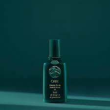 Eternal Curls Polish & Protect Oil bottle on teal background; botanical hair oil with castor, apricot and coconut oils.